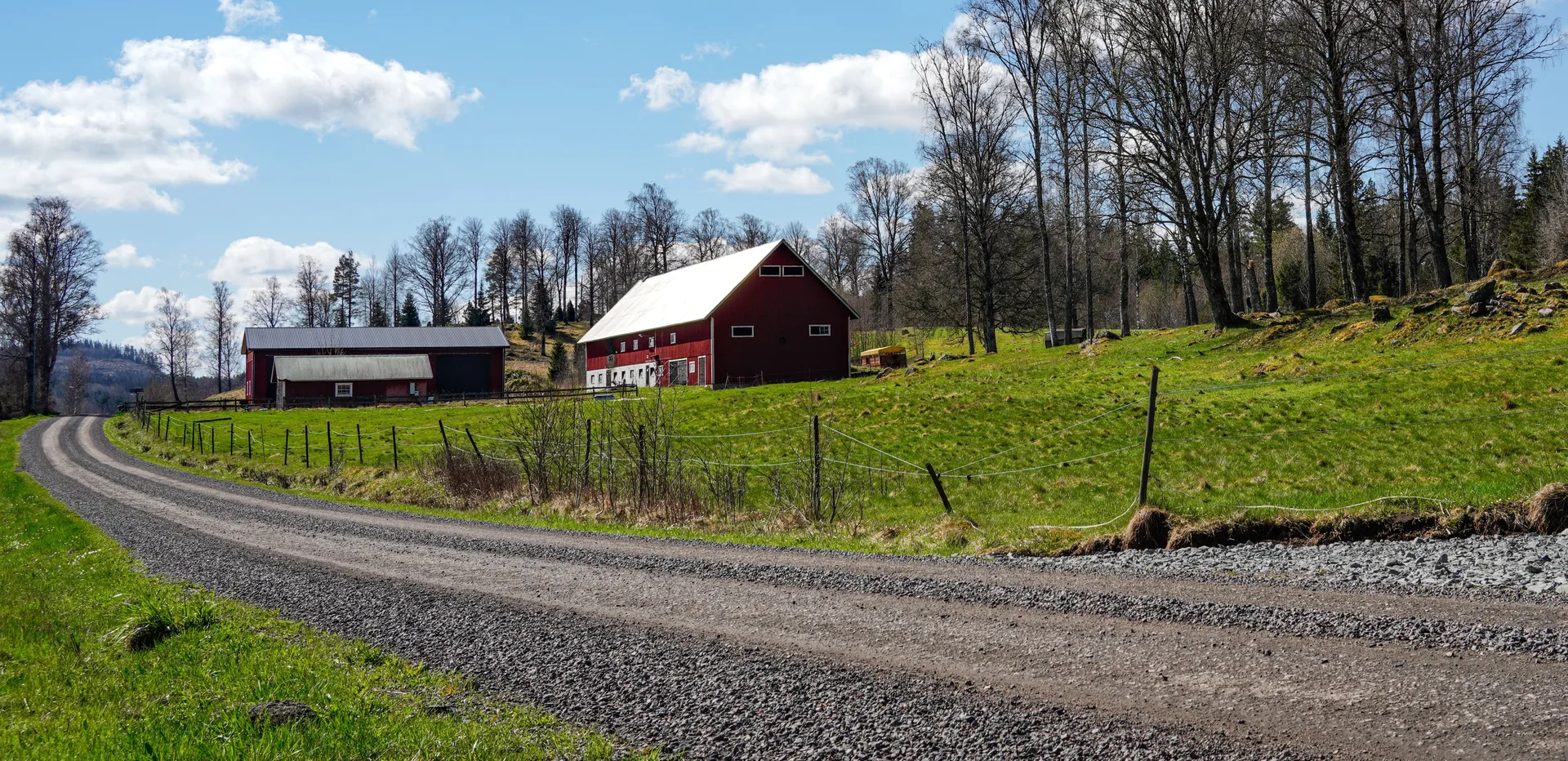 Red pole barn at the end of a gravel driveway in Simcoe County